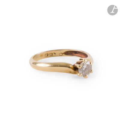 a close up of a gold ring with a diamond on it