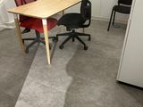 a desk with a chair and a computer on it