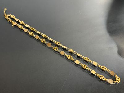 a pair of gold bracelets on a black surface