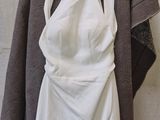 a picture of a white dress hanging on a hanger