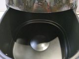 a reflection of a person taking a picture in the reflection of a toaster