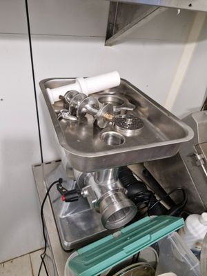 a kitchen with a sink and a stove with pots and pans in it