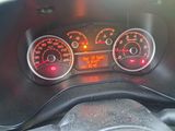 a close up of a car dashboard with a speedometer and gauges