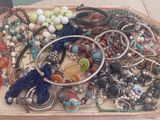 a tray with many different types of jewelry on it