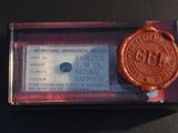 a wax seal that is on top of a piece of paper