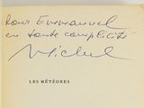 an old book with a handwritten quote on it sitting on top of a table