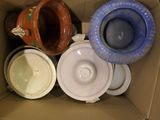 a cardboard box filled with many different types of bowls