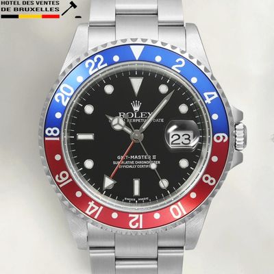 a rolex watch with a red, white and blue bezel