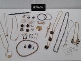 many different types of jewelry displayed on a table