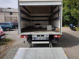 a white truck with a flat bed in a parking lot