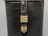 a close up of a black box with a gold clasp on it