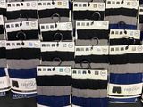 many pairs of men ' s socks on display in a store