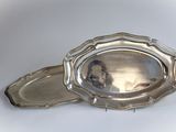 a silver tray with a silver lid on a white surface