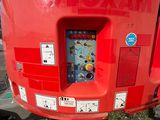 a red machine that is sitting in the grass