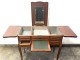 a small wooden table with a mirror on top of it