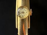an image of a close up of a wrist watch on a black surface