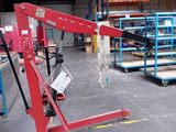 une grue rouge qui se trouve au milieu d'un entrepôt