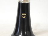 a close up of a black clarinet with a white background