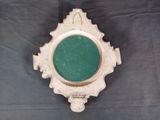 a clock with a green face on a black background