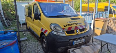 a yellow van that is parked next to a table and chairs