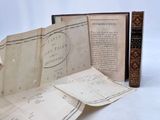 two old books that are open on a white surface