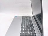 a laptop computer sitting on a white surface with a keyboard