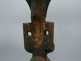 a close up of a wooden sculpture on a white surface