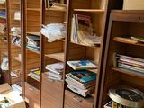 a room with a lot of books and boxes on the floor