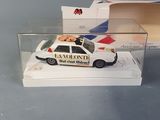 a toy police car in a display case on a table