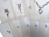 six white cards with different designs and a pair of scissors