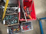 many different tools in a box on the floor