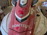 a red and white jet ski parked in a garage