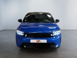 the front view of a blue car in a showroom