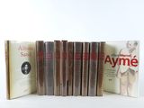 several books are lined up in a row on a white surface