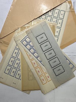several envelopes are stacked on top of each other on a table