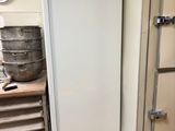a white refrigerator in a kitchen next to other appliances