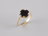 a gold ring with a black stone in the center