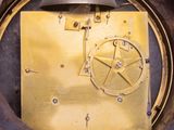 a clock that is sitting in a hole in the wall