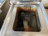 a deep fryer with a fork sticking out of it
