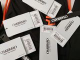a pile of clothes with tags on them on a table