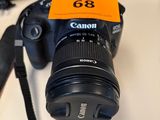 a black camera with a yellow tag on it sitting on a table