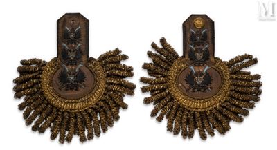 two pairs of earrings with gold and black designs on them