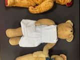 three teddy bears that are laying on a table