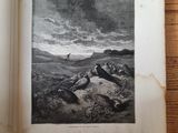 an open book on a wooden table with a picture of a man sitting on a rock