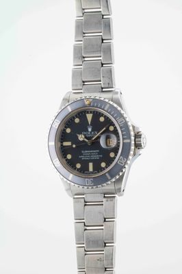 an image of a wrist watch with a black dial on a silver bracelet