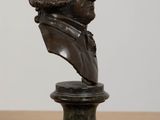 a close up of a bronze bust of a man on a pedestal