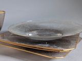 two plates and a bowl sitting on a table