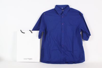 blue button up shirt next to a white shopping bag on a white surface
