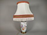 a lamp that is sitting on a table with a lamp shade on it