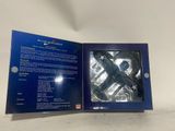 a close up of a blue box containing a pair of scissors
